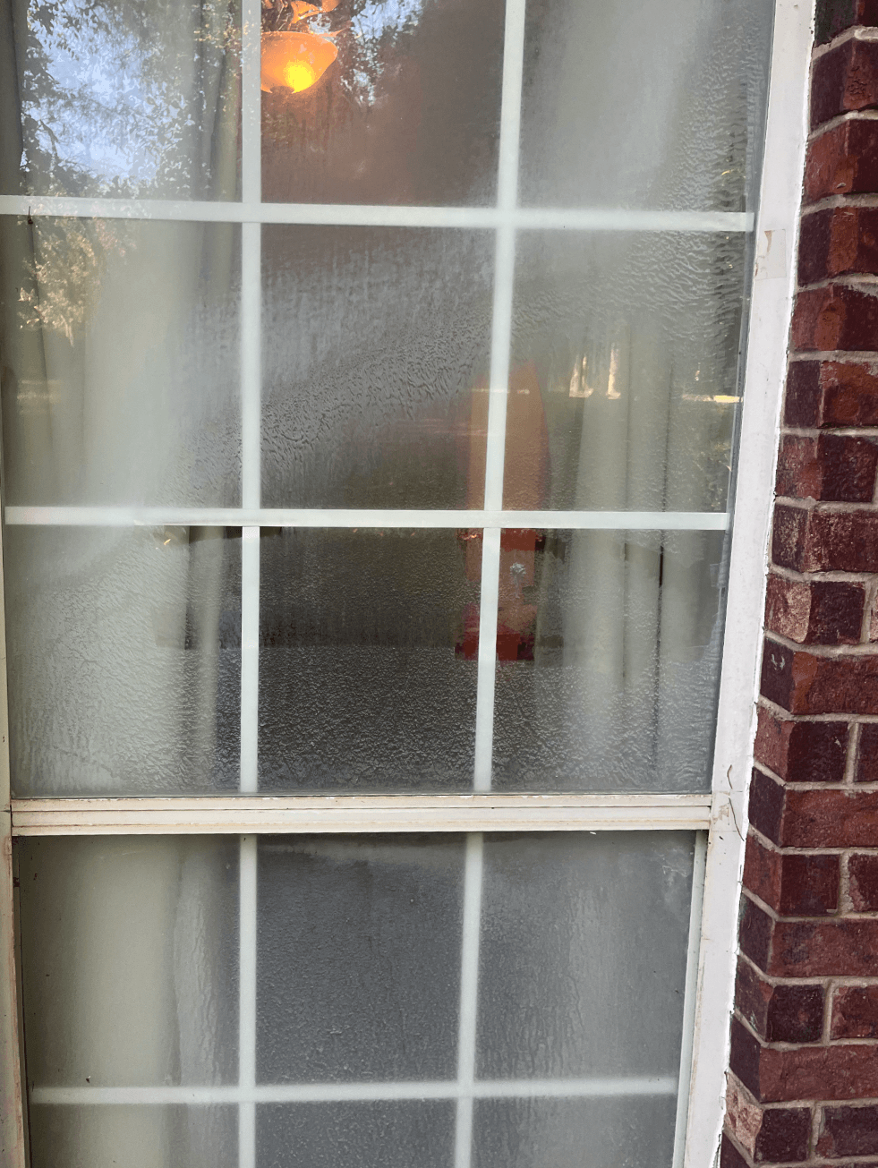 Window panel before cleaning with visible residue