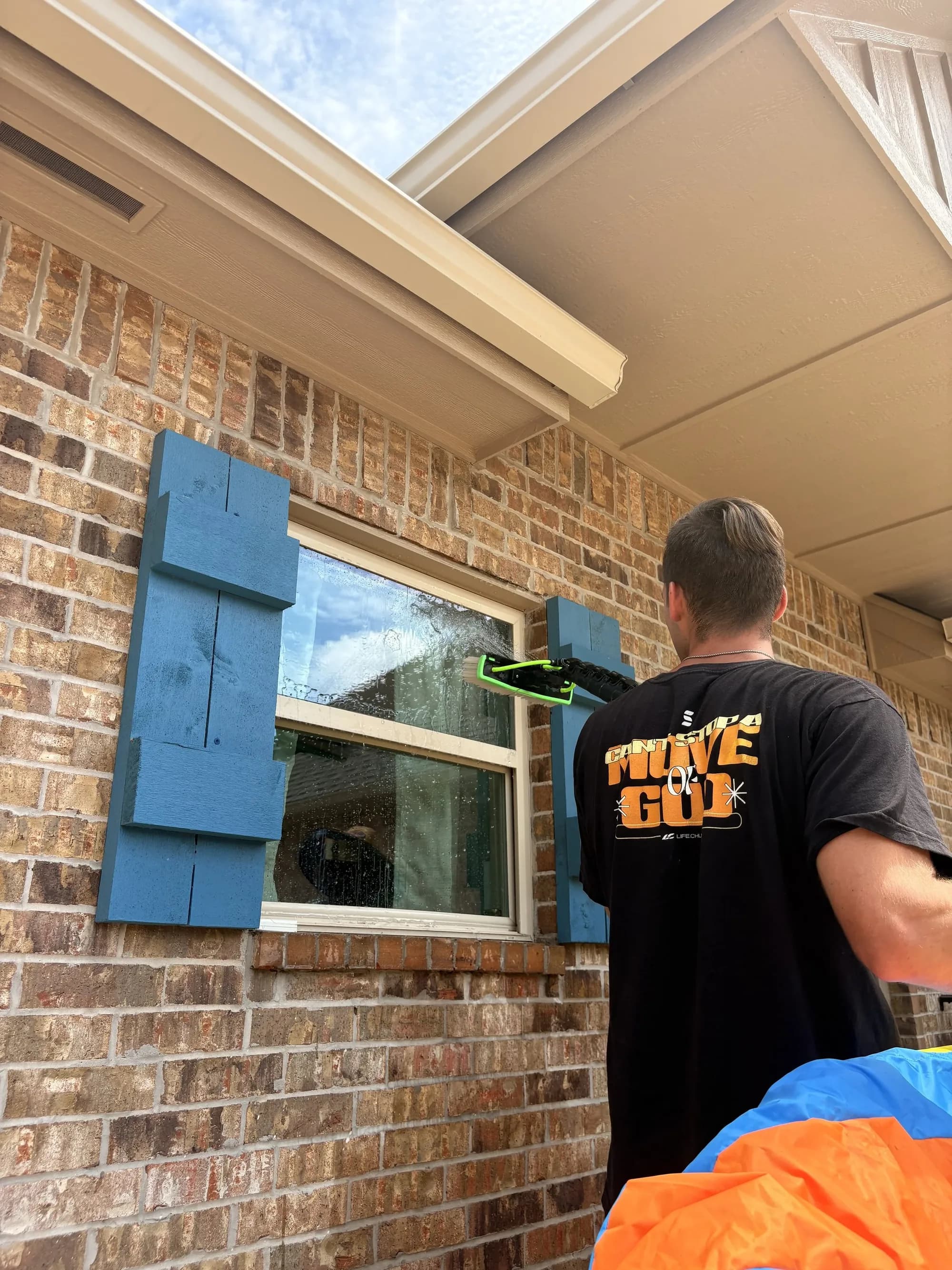 Tent Makers technician cleaning exterior windows
