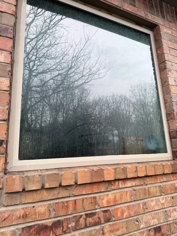 Window with water spotting before hard-water treatment